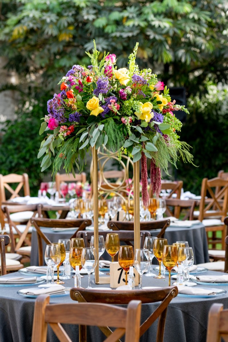 pink and yellow flowers on clear glass vase